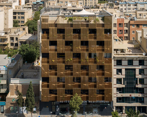 vertically laid wooden blinds screen sarv office building's interiors in tehran