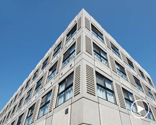 textured concrete facade envelops living facility center in japan by SAKO architects