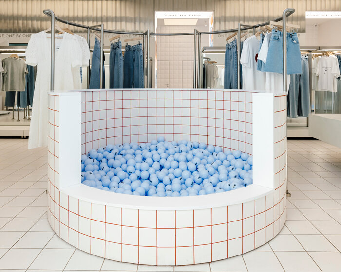 whimsical ball-filled pool takes center stage at between the walls' clothing store in kyiv