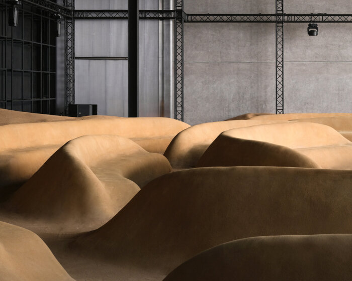 bottega veneta sculpts sand-colored seats into patterns of sound waves for dubai installation