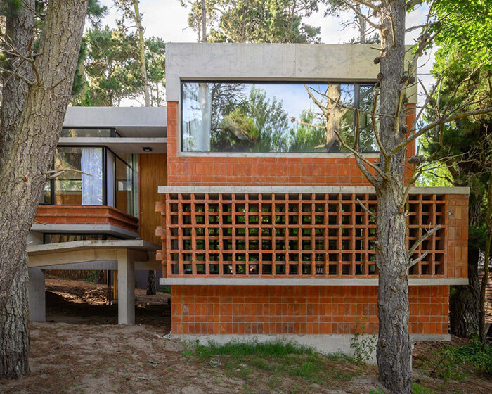 exposed concrete and brick residence adopts 1970s chalet typology in buenos aires forest