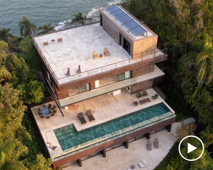 FCstudio's coastal house stacks steel, glass, & stone layers amid são paulo's rugged terrain