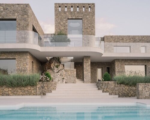 wrapped in stone and rooted by an olive tree, corfu house overlooks the sea in greece