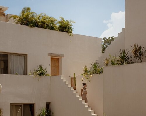 stacked chukum & stone volumes wrapped in green terraces shape RA!'s residences in tulum