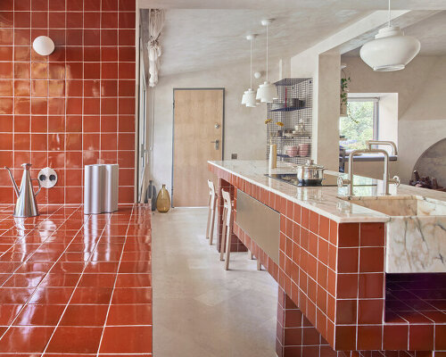 handcrafted burgundy tiles clad window frames of renovated 70s bungalow in madrid