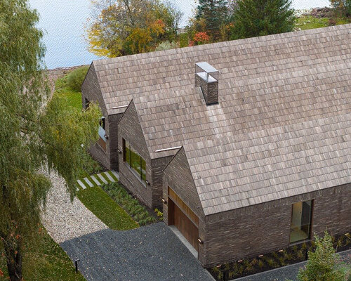 atelier échelle coats lakeside gallery residence in dark clay bricks, nodding to québec's barns