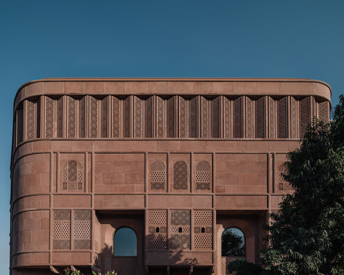 hand-carved red sandstone clads jewelry store's facade by studio lotus in jaipur