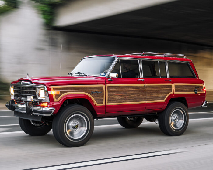 vigilante restores 1988 jeep wagoneer into a crimson truck with wood panels on the sides