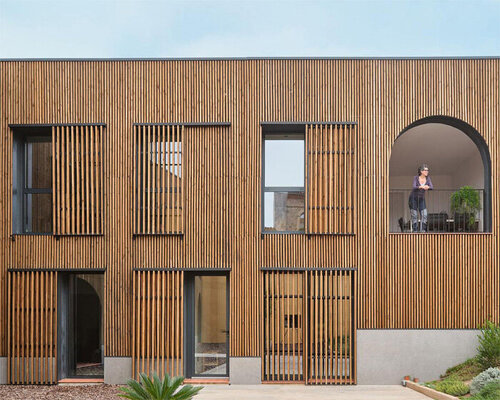 wooden sliding shutters frame arched openings in spanish renovation by sergi pons studio