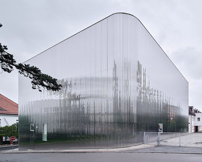 SLAS architekci wraps concert hall in poland with shimmering steel facade