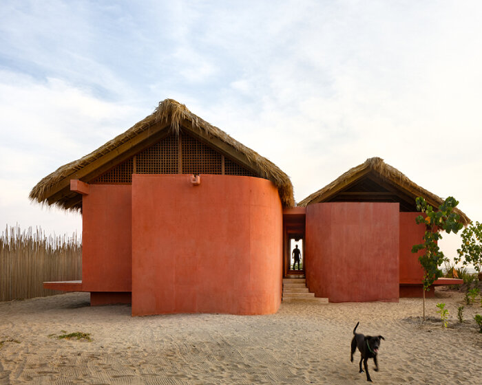 palm fronds top bloqe arquitectura's cluster of traditional houses along oaxaca coastline