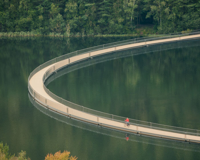 floating cycling bridge curves through pond in belgium adapting to water levels