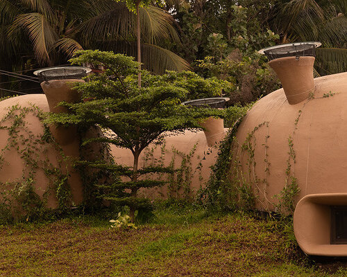 fluid ferrocement shell sculpts cavernous spaces for earthscape studio's home in india