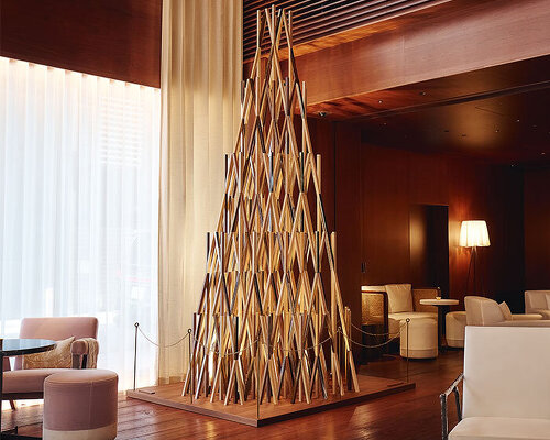 kengo kuma's wooden christmas tree sculptures illuminate EDITION hotels in tokyo