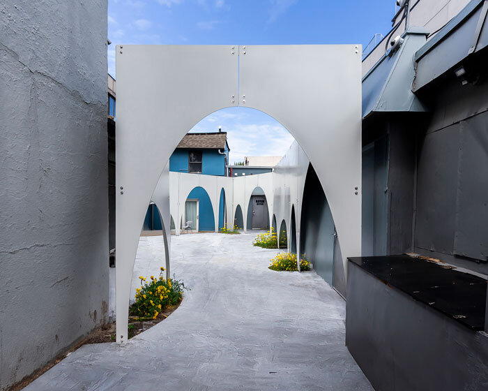 multi-arched steel installation by mian ye outlines urban courtyard in brooklyn