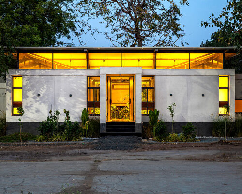 inverted winged hip roof cantilevers over reconstructed office space by compartment S4