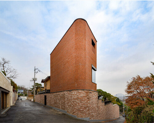 monolithic brick-clad annex by LKSA expands existing residence in korean mountains