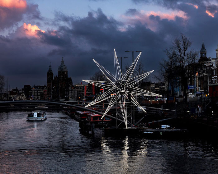 polaris glowing star installation lights up in the heart of amsterdam