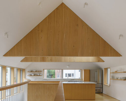 clad in grey and black wood, gabled ardmore house by kwong von glinow stands in chicago