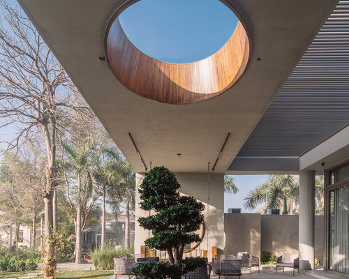 circular wooden apertures puncture through multi-use pavilion by UA lab in india