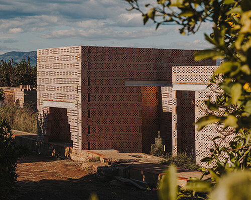 cross-shaped perforations filter light through bona fide taller’s ceramic pavilions in valencia