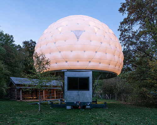 mobile sleeping hut combines stainless steel trailer with double-shell inflatable dome