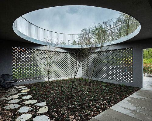 perforated concrete facade encloses courtyard within geometric family house in zagreb