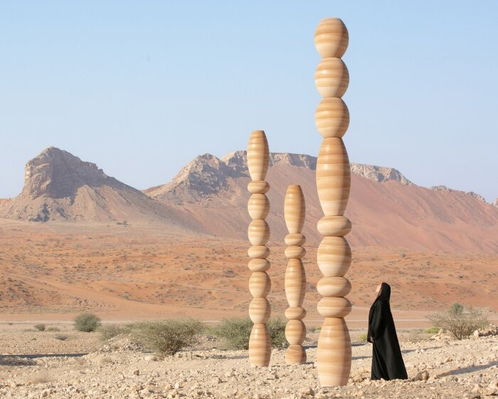 sculpted from sand, karim + elias' desert relics installation rises like ancient totems in UAE