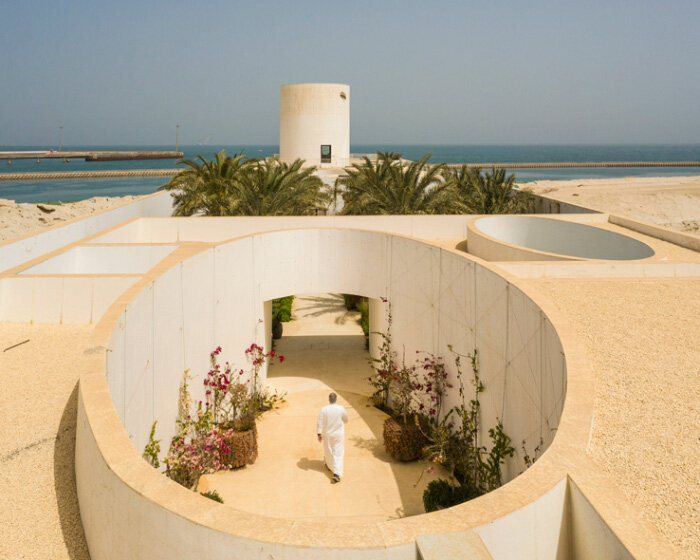 lighthouse-like tower rises amid white walls of TAEP/AAP's residence in kuwait