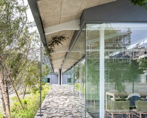 industrial metal trusses and local stones shape inorder studio's property showroom in taiwan