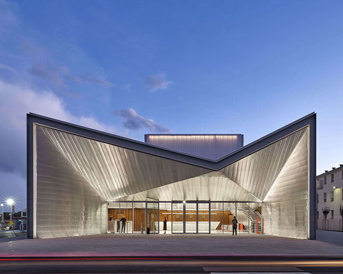 teatro borsoni unfolds sculptural geometric facade along square in northern italy