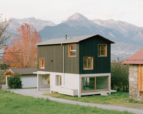 lionel ballmer architectes' charred wood house echoes traditional barns of rural switzerland