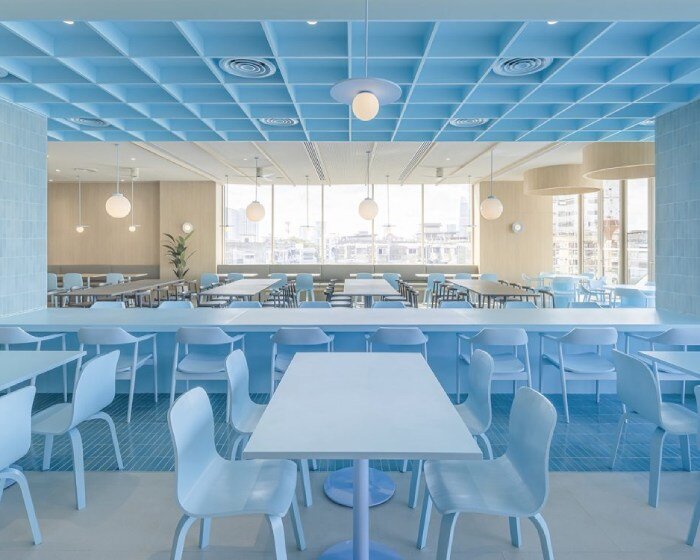 baby blue hues engulf onion's multipurpose school canteen in bangkok