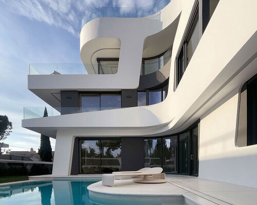 sculptural ribbon-like volumes compose dual residence by direction architects in athens