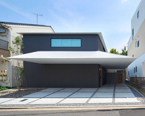 floating white eave slices through black volume of wooden residence by airhouse in japan