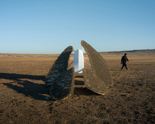 crafted with thatch and gauze, oas/s-nomad installation floats above mongolia's grassland