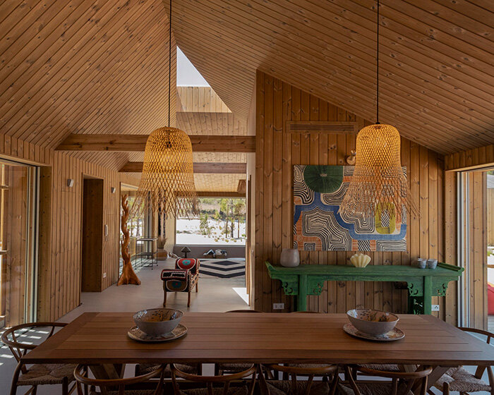 donavan house: PIMAA clusters timber dwellings along sandy coastal site in portugal